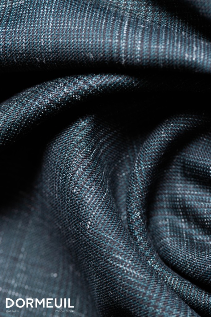 Close-up of dark Dormeuil suiting fabric showing fine twill weave and texture