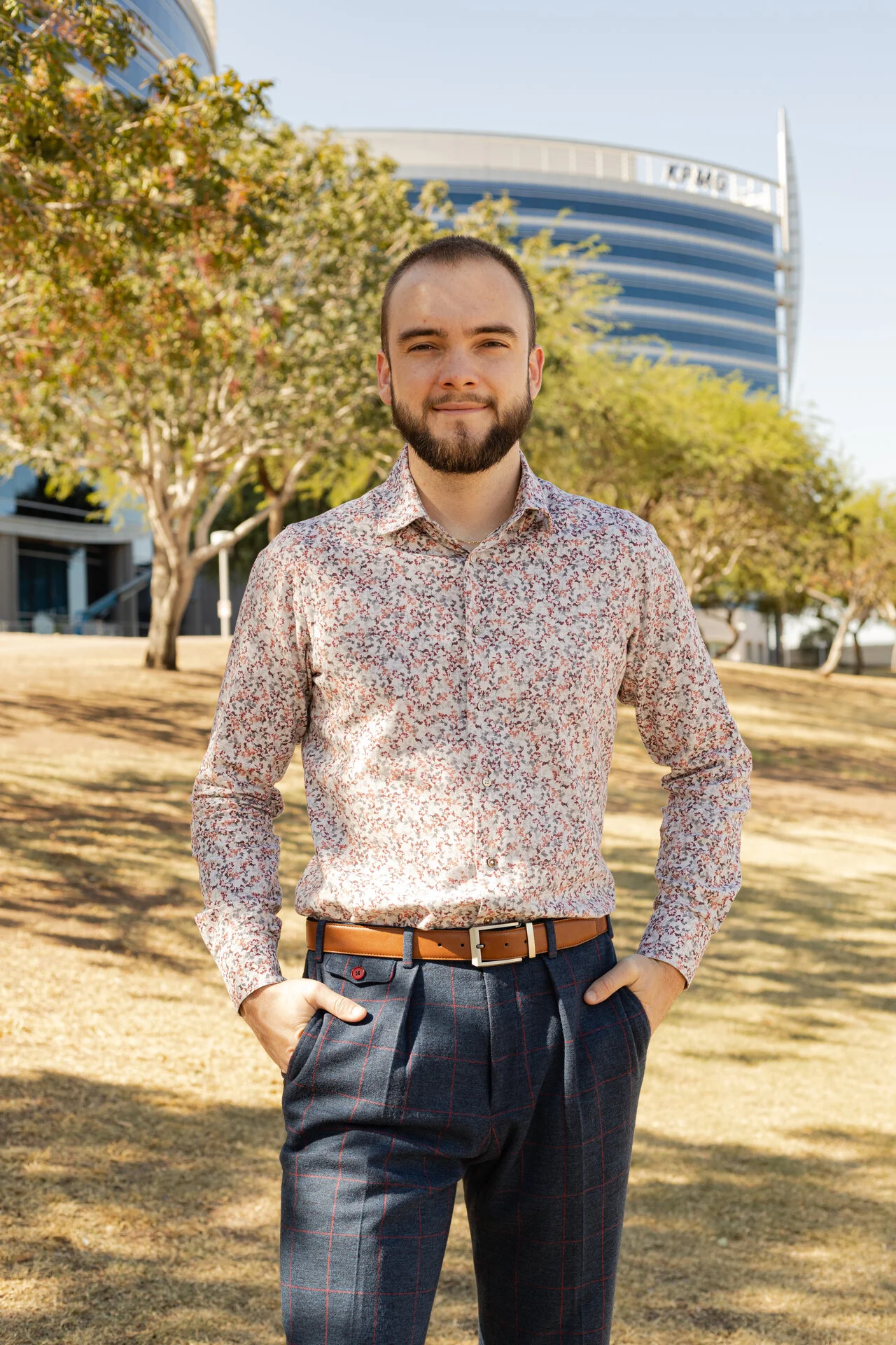 Man in floral print shirt, smiling