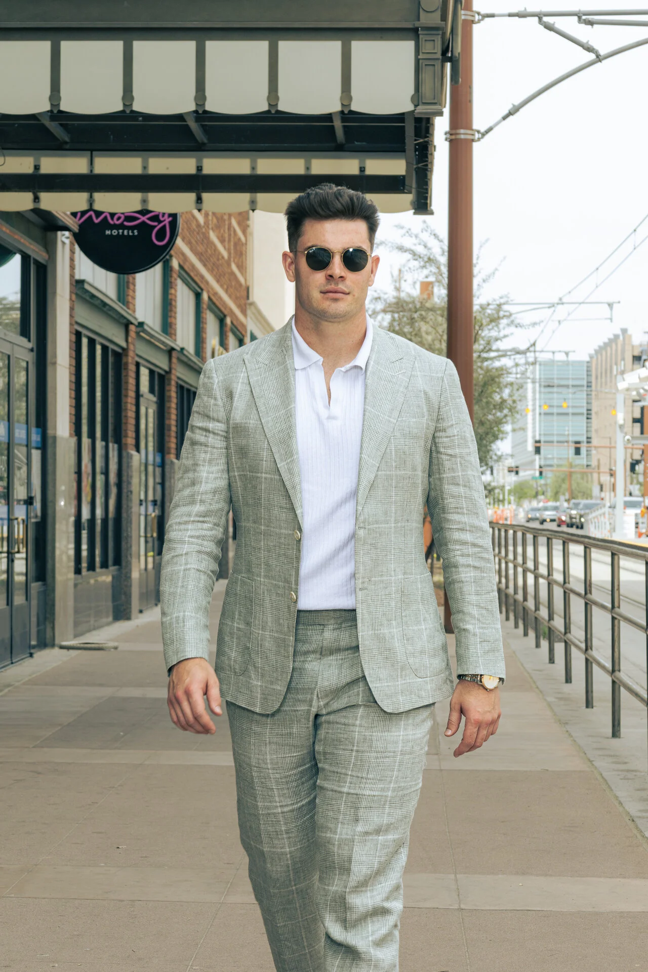 Man in light gray plaid suit with sunglasses