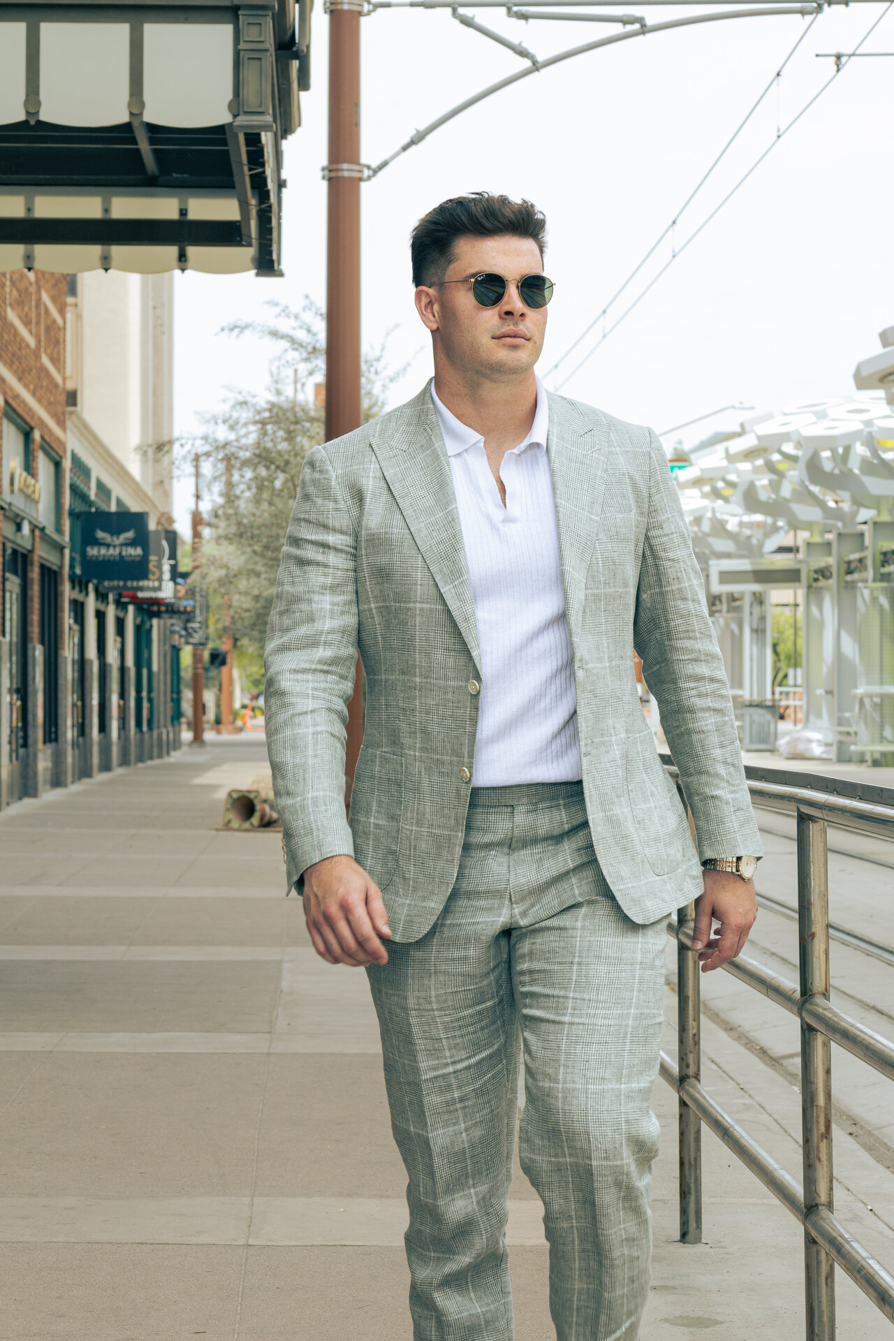 Man in light gray plaid suit with sunglasses, front view