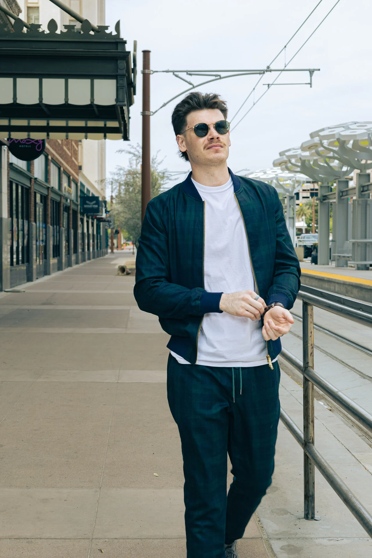 Man in navy blue bomber jacket and pants