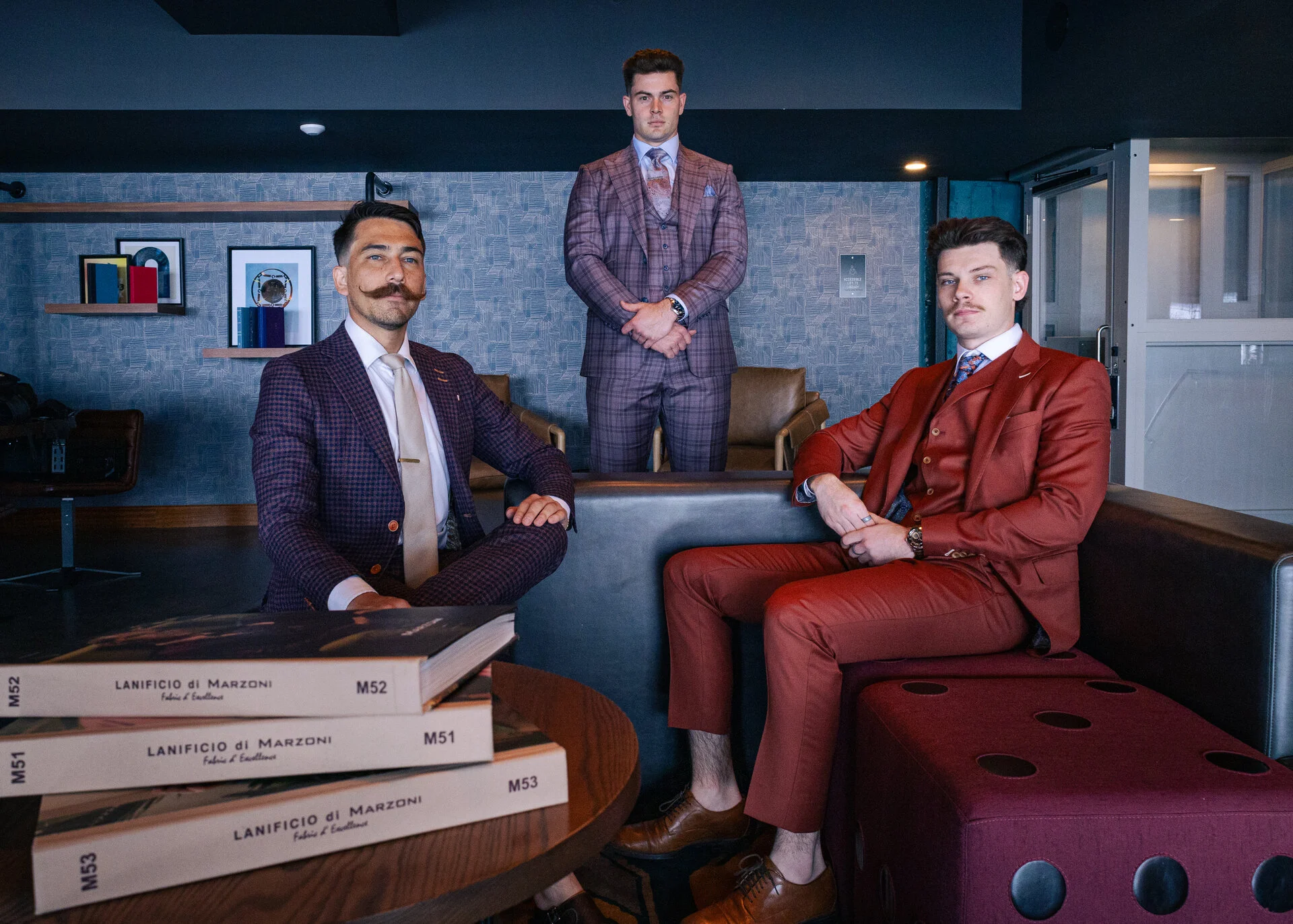 Three men in colorful suits, studio setting