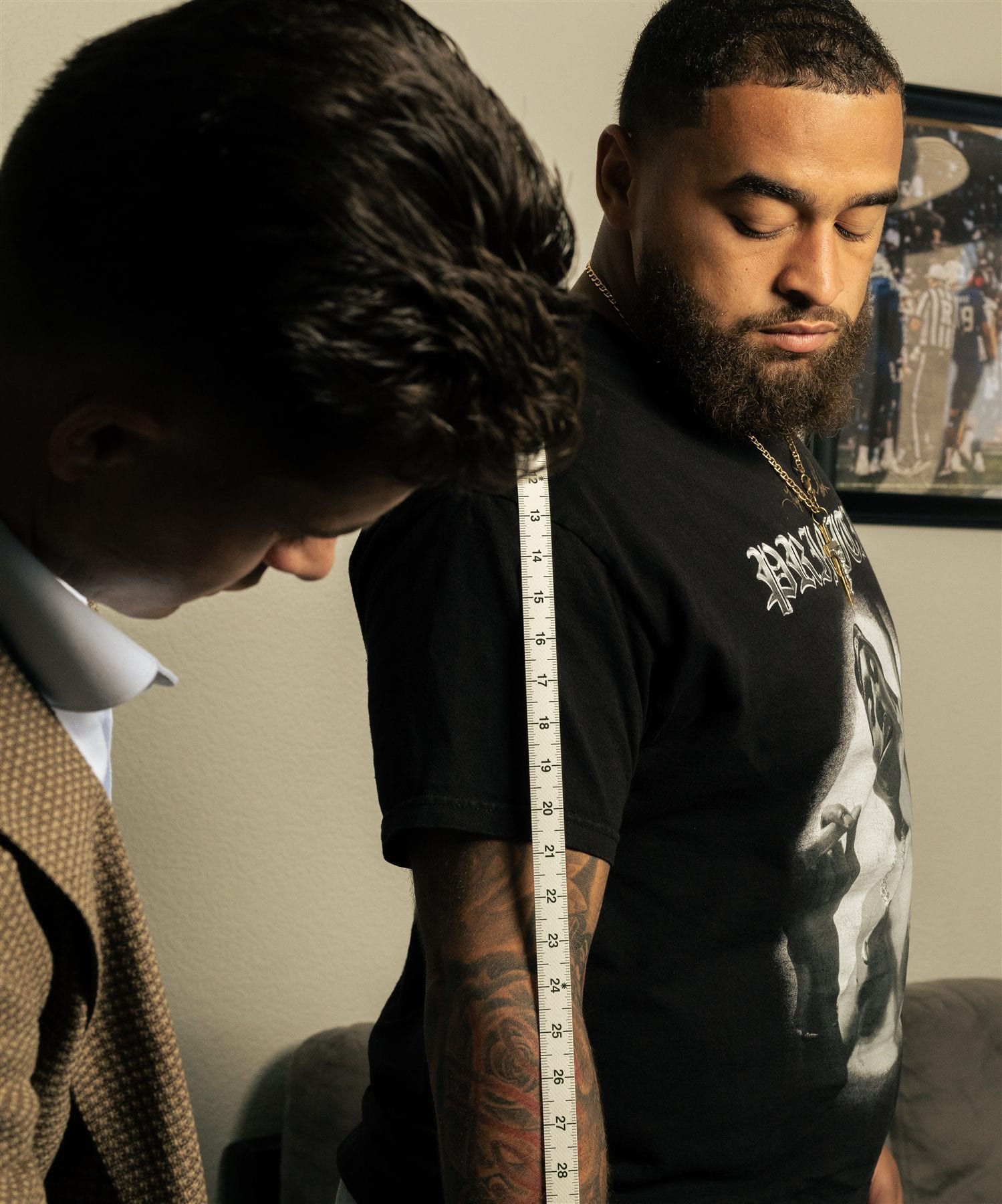 Private custom suit sleeve measurement during fitting appointment